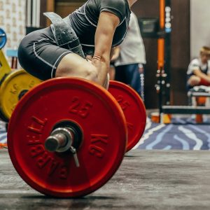 side view female athlete perform deadlift in powerlifting competition, power sports games